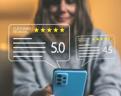 a woman holds a smartphone displaying five stars, symbolizing a high rating or positive feedback