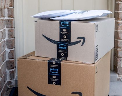 Amazon prime package stacked up in front of a residential home