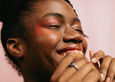 Smiling black woman with eyeshadow