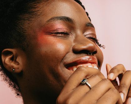 Smiling black woman with eyeshadow