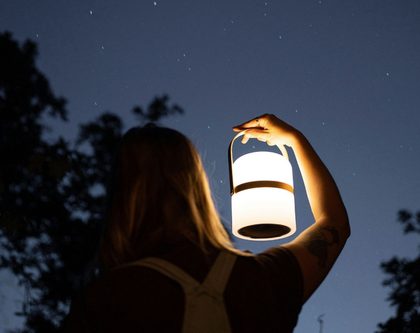 woman holding lantern in night sky
